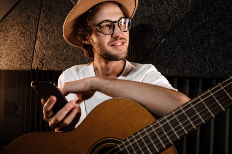 portrait-of-attractive-male-musician-with-guitar-a-2021-08-28-14-51-13-utc