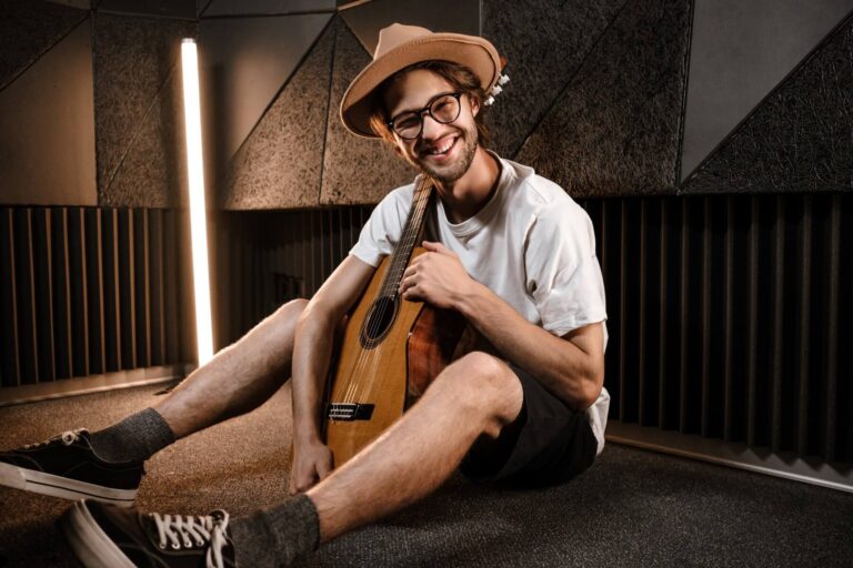 young-attractive-man-with-guitar-happily-looking-i-2021-08-28-14-51-17-utc