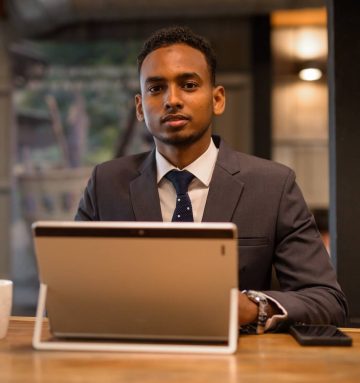 young-african-businessman-using-laptop-computer-at-2021-08-29-17-47-17-utc